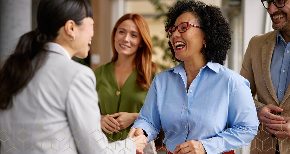 Group of Executives, two women handshake